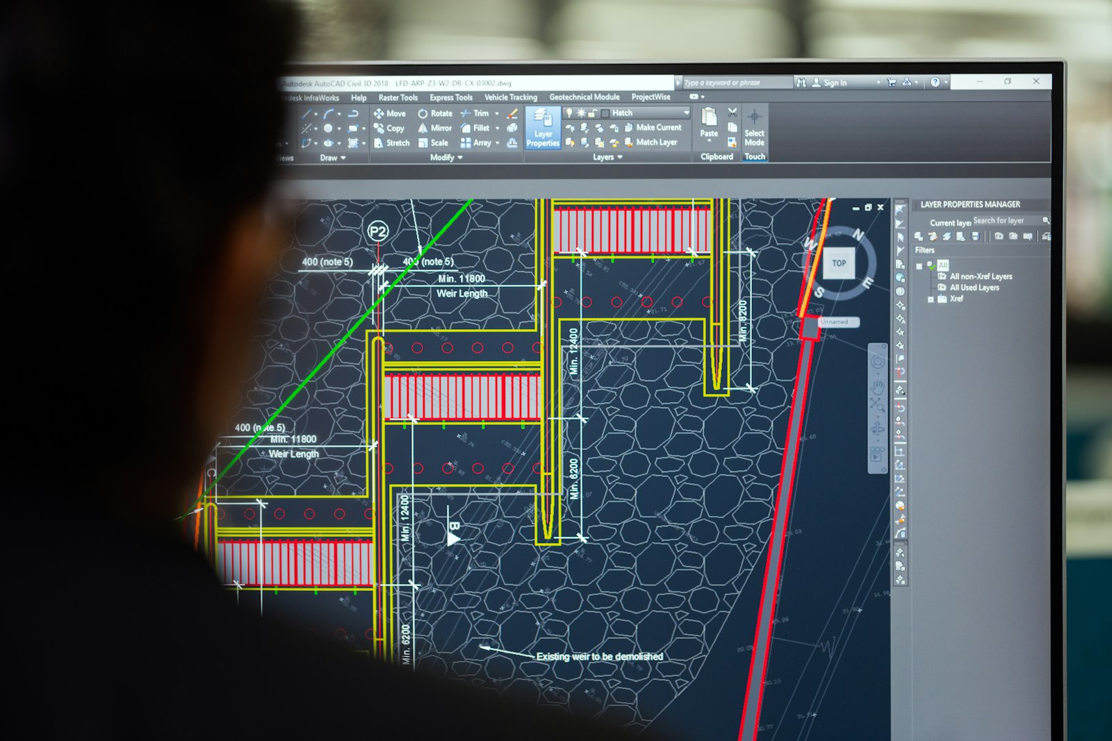 Person reviewing a technical drawing in CAD software